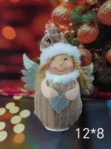 Close-up detail of a plush Christmas angel ornament with silver wings and a glittery heart.