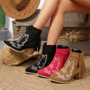 Detail of western embroidered ankle boots with fringe and chunky heels in multiple colors