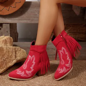 Detailed view of red Western fringe ankle boots with white wing embroidery