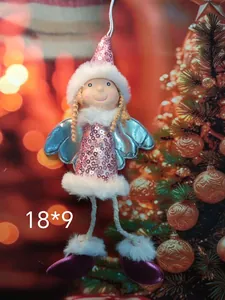 Close-up of a pink sequined Christmas angel plush ornament with white fur trim.