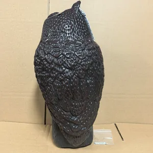 Back view of realistic brown plastic owl decoy for garden bird and pest control