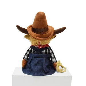 Back view of Highland cow plush toy in cowboy outfit with denim overalls and rope