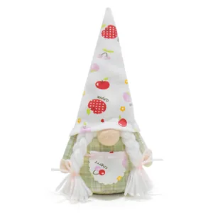 Detailed view of plush gnome doll with fruit pattern hat and white braided hair