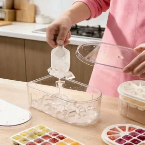 Detailed view of clear ice storage box with colorful juice ice cubes and a white scoop