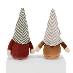 Detail view of two autumn faceless gnomes with striped hats for harvest festival decor