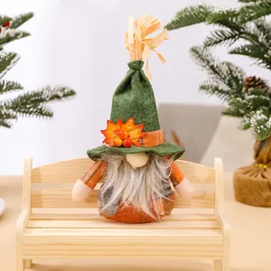 Handmade faceless Thanksgiving gnome doll decoration with maple leaf on green hat