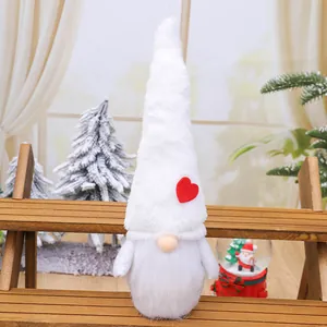 Nordic style plush Christmas gnome with tall white hat and red heart patch decoration.