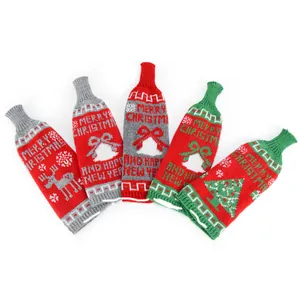 Set of five festive knitted Christmas wine bottle covers with reindeer and tree designs
