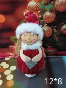 Detail of a Nordic plush angel ornament with a silver heart and blonde pigtails.