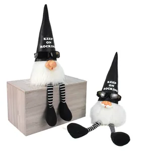 Detail view of two rock-themed Christmas gnomes with sunglasses and keep on rocking hats
