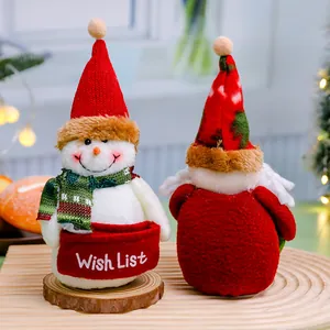 Close-up view of adorable Christmas snowman and Santa Claus plush dolls for holiday table decor