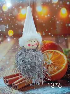 Close-up of a handmade festive Christmas angel doll ornament with fuzzy silver fringe body