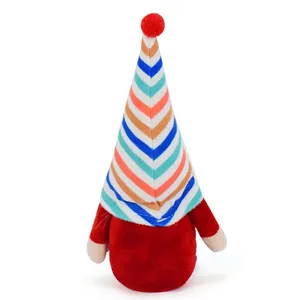 Close-up detail of a colorful striped hat on a soft red Christmas gnome plush doll