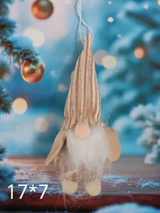 Macro detail of a soft plush Christmas gnome hanging ornament with a tall striped hat