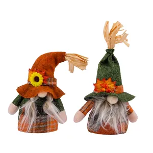 Pair of Thanksgiving faceless gnomes featuring autumn leaves and sunflower decorations