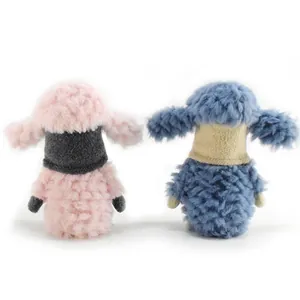Close-up detail showing the soft plush texture of pink and blue sheep gnome ornaments from behind