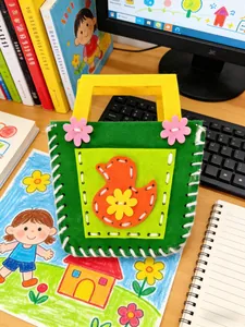 Handmade green non-woven felt bag for kids featuring a cute orange duck DIY craft design