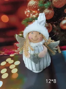 Detail view of a Nordic plush angel ornament with silver wings and a white striped hat.