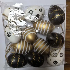 Detailed view of 6cm black and gold painted Easter eggs with jute hanging loops