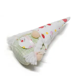Close-up of fruit-themed faceless gnome plush decoration with strawberry pattern
