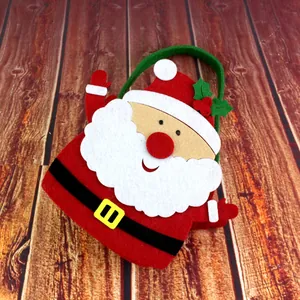 Festive Santa Claus felt Christmas gift handbag with green handle on wooden background
