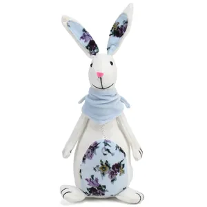 Macro detail of a handmade linen Easter bunny figurine with blue floral fabric accents