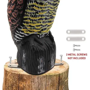 Detailed macro view of plastic owl decoy mounting base with metal plates for garden