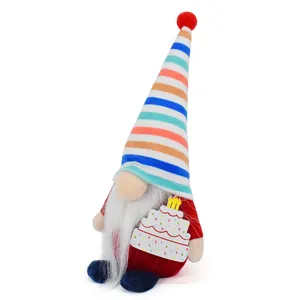 Detailed view of colorful plush birthday gnome doll holding a tiny cake with candles