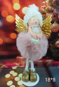 Close-up of cute pink plush angel doll Christmas tree ornament with golden wings.