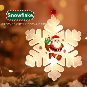 Detail view of a glowing snowflake-shaped LED Christmas light with Santa Claus motif