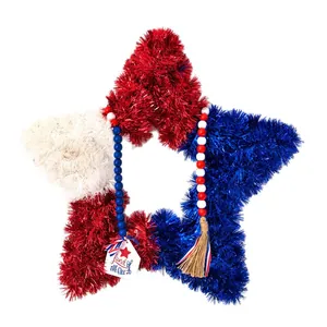 Patriotic tinsel star wreath with wooden beads and tassel for 4th of July decor.