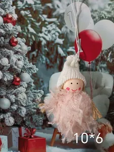 Close-up of a pink plush Christmas angel girl ornament with a white knit hat