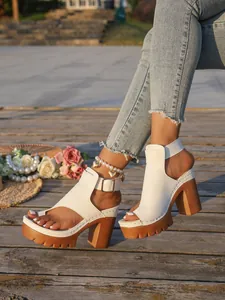 Detail view of white platform chunky high heel sandals with toe-thong and buckle strap.