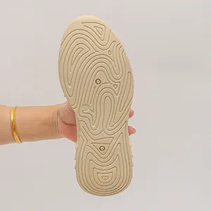 Vue détaillée du motif de semelle antidérapante ondulée sur une chaussure de sport beige