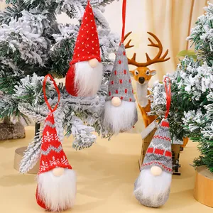 Set of four handmade knitted Christmas gnome ornaments for festive holiday tree decoration.