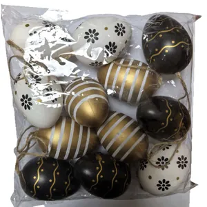 Decorative pack of twelve 6cm black gold and white painted Easter eggs with twine loops
