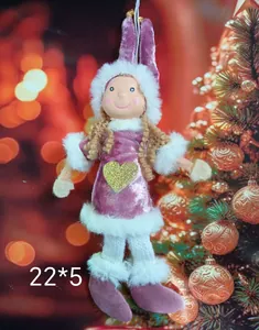 Close-up of cute plush Christmas doll ornament with purple velvet dress and gold heart