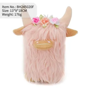 Cute pink Highland Cow plush toy featuring a colorful floral headband on white background