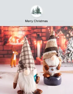 Two coffee-themed Christmas gnomes in a cozy festive setting with a warm fireplace background.