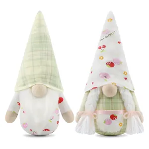 Close-up of fruit-themed faceless gnome plush dolls with strawberry and cherry patterns
