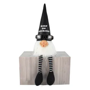 Detailed view of rocker gnome sitting on a wooden block with KEEP ON ROCKING hat