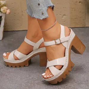 Detailed view of women's beige chunky heel sandals with crossover straps and platform
