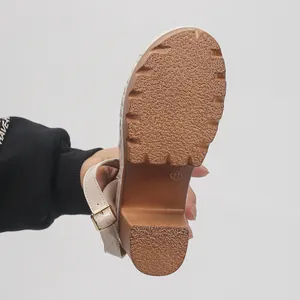 Close-up detail of the anti-slip textured sole and sturdy chunky heel on the sandal