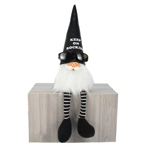 Detail of a cool rock gnome ornament wearing sunglasses and black 'Keep On Rocking' leather hat.