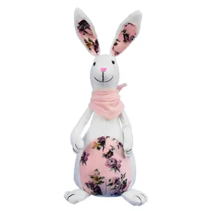 Detailed view of linen Easter bunny decoration with floral patterns and pink scarf