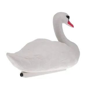 Side view detail of a realistic white swan garden decoy for outdoor pond decoration