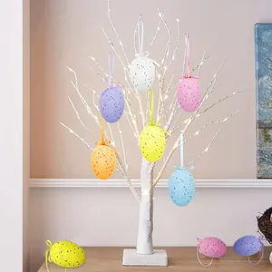 Spotted Easter eggs hanging on a white decorative LED tree for festive home decor.