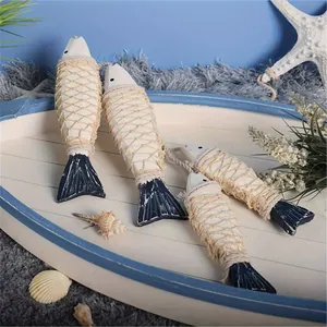 Detail of marine style wooden fish ornaments with hemp rope in a boat tray