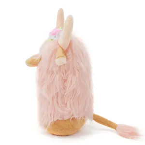 Side view of a cute pink Highland Cow plush gnome with soft long fur and floral detail.