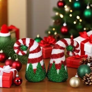Close-up of a pair of glittery red and white striped Christmas elf hats for party decor